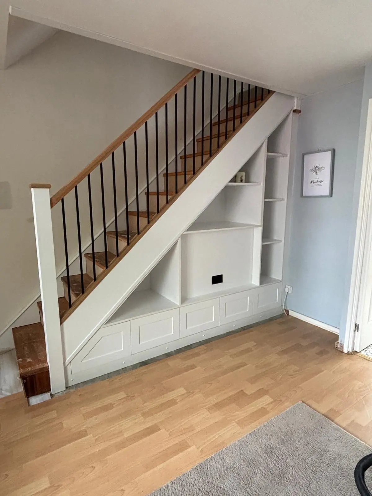 Hallway shoe storage and cloak cupboard built under the staircase in Manchester